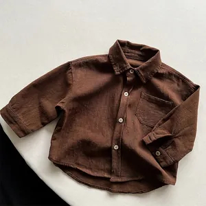 Detailed flat lay of long sleeve dark brown cotton shirt with wood buttons and pocket