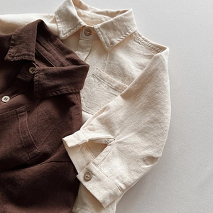 Detail view of cotton long-sleeve shirts in dark brown and beige with textured fabric