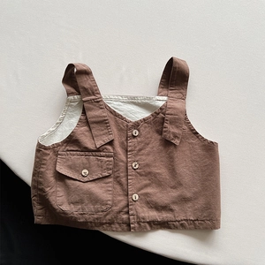 Detailed close-up of retro kids vest featuring cotton linen texture and wooden buttons