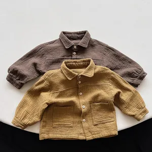 Close-up of double-layer cotton fabric texture and wooden buttons on kids jacket