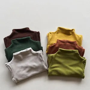 Stack of colorful kids' thermal turtlenecks in soft knit fabric for autumn and winter