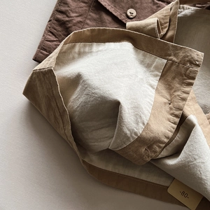 Minimalist kids khaki canvas vest featuring premium lining and stitched detail