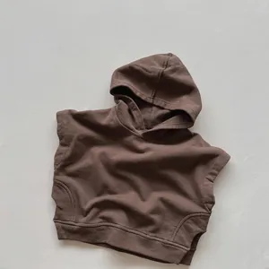 Detailed close-up of dark brown hooded cotton knit vest with ribbed hem for toddlers