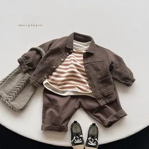 Detailed view of children's cotton 3-piece set with brown shirt and striped tee