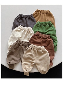 Flat lay showing various colors of elastic waist cotton jogger pants for kids