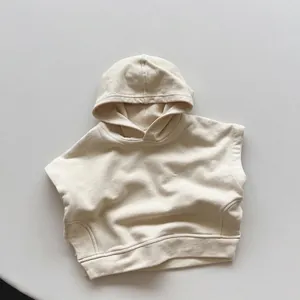 Detail of oatmeal hooded cotton vest showing soft fleece texture and ribbed hem