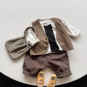 Flat lay of Korean style retro kids cotton outfit set with vest, T-shirt and shorts