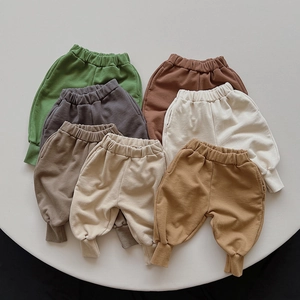Detailed view of children's cotton joggers in various earth tones with ribbed cuffs
