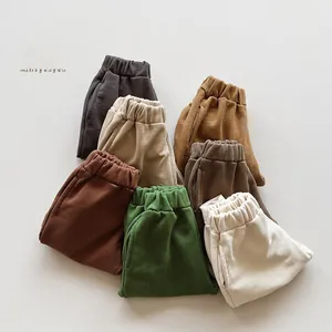 Detailed stack of seven colors cotton sweatpants for kids in soft fleece fabric