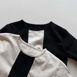 Close-up of crewneck cotton knit T-shirts featuring black and beige striped patterns