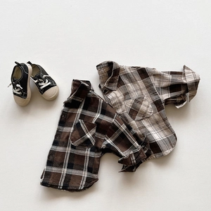 Flat lay detail of vintage plaid cotton shirts and black canvas shoes for children