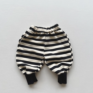 Detailed view of elastic waistband and ribbed cuffs on black and white striped kids joggers