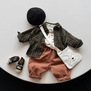 Kids plaid shirt set with green checkered top, red pants, and bear canvas bag accessory