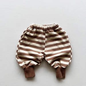 Detailed close-up of brown striped kids joggers with elastic waist and ribbed cuffs