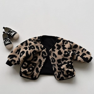 Detail of kids leopard print fleece jacket showing plush texture and black ribbed cuffs