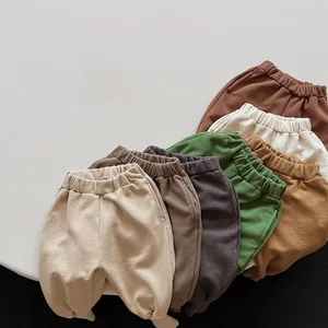 Detailed view of elastic waistbands on multi-colored loose cotton trousers for kids