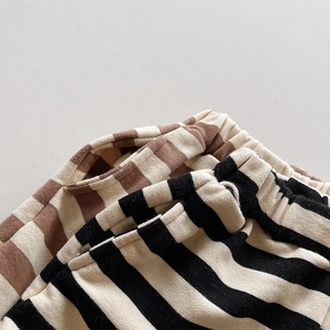Close-up of comfortable elastic waistband and side pocket details on striped kids pants
