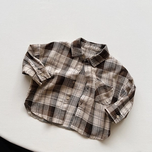 Close-up of retro plaid pattern and wooden buttons on children's cotton shirt