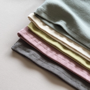 Detailed texture of soft cotton base layer fabrics in assorted autumn colors with stitching