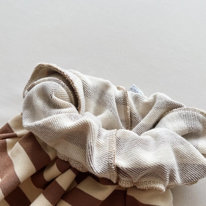 Detail of children's striped pants showing elastic cuffs and soft french terry lining