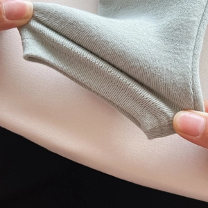 Detail shot of stretchy ribbed cuffs on a soft cotton thermal undershirt for children