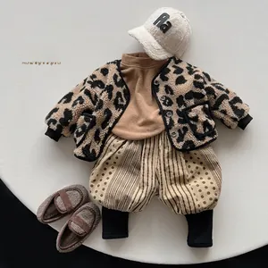 Flat lay of Korean style kids winter outfit set with leopard fleece jacket and striped pants