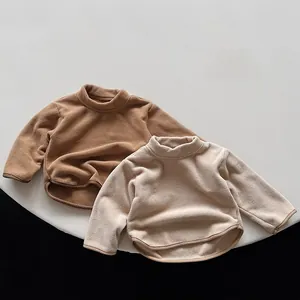Detail of warm thermal fleece kid tops showing soft texture and high neck in brown and beige