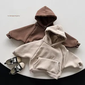Detail view of thick fleece hooded sweatshirts for kids in brown and beige tones