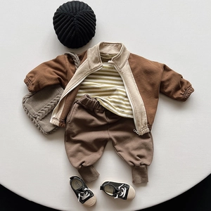 Detailed flat lay of children's cotton tracksuit with striped shirt and brown zip jacket