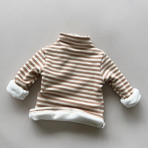 Close-up of kids' striped sweater showing the thick white fleece lining for winter warmth