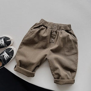 Kids brown casual trousers with elastic waist, decorative wooden buttons and side pockets