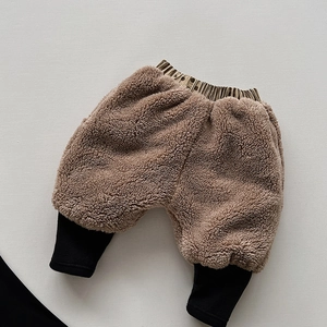 Detail of warm brown teddy fleece trousers for kids with black ribbed elastic cuffs