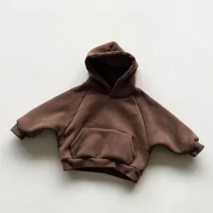 Detail view of coffee brown kids hoodie showing soft fleece texture and kangaroo pocket