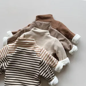 Detail view of five warm fleece-lined turtlenecks for kids in solid and striped earthy tones