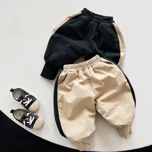 Detail of winter thick fleece-lined kids joggers with contrast side stripes and ribbed cuffs