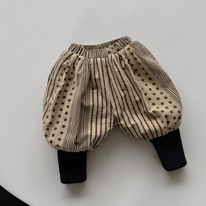 Detailed view of beige toddler bloomers with mixed polka dot patterns and ribbed black cuffs