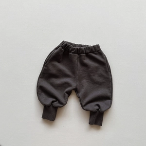 Detailed close-up of dark grey kids joggers with elastic waist and ribbed cuffs