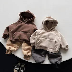 Flat lay of soft children fleece hoodies in earthy tones with ribbed cuffs and big pockets