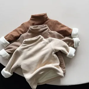Close-up of children fleece thermal tops showing soft interior lining and ribbed necklines