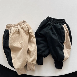 Detail view of thick fleece-lined kids joggers with contrast color block and ribbed cuffs