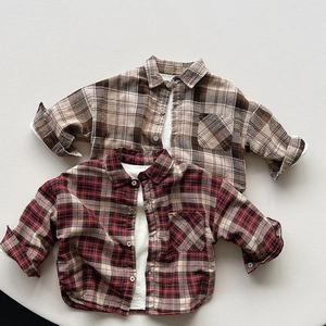 Detail of warm fleece-lined flannel plaid shirts for kids in brown and red colors