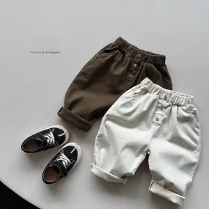 Detail view of children's fleece joggers with elastic waist and decorative buttons