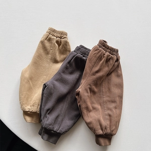 Detailed texture of thick corduroy trousers in khaki, dark gray, and brown colors