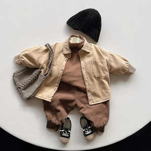 Flat lay of vintage style kids thermal beige jacket and corduroy trousers outfit set
