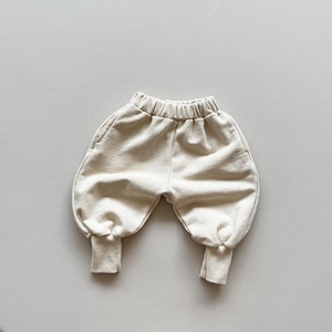 Close-up of children's cotton jogger pants with elastic waistband and ribbed cuffs detail