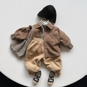 Flat lay of vintage kids fleece-lined corduroy shirt outfit for winter fashion