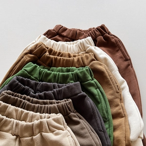 Elastic waist details on multi-color cotton kids trousers with soft knit texture