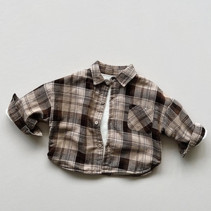 Detail view of children's fleece-lined plaid shirt featuring a cozy sherpa wool lining