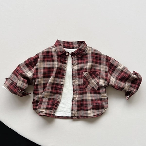 Close-up of kids warm plaid shirt with thick white fleece lining and chest pocket detail