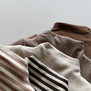 Close-up of warm fleece lined thermal knit tops in various colors and striped patterns